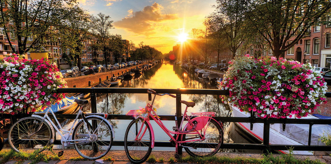 Amsterdam canal and bikes at sunrise